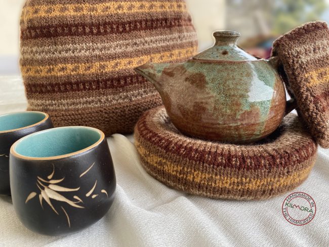 Hand knit woollen tea cosie set with a base, teapot cover and a flap to hold the handle