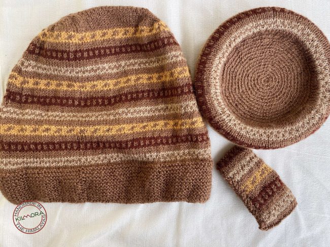 Hand knit woollen tea cosie set with a base, teapot cover and a flap to hold the handle