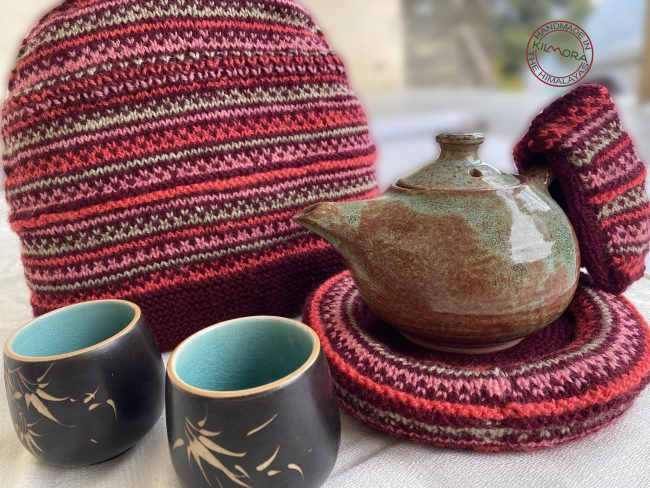 Hand knit woollen tea cosie set with a base, teapot cover and a flap to hold the handle