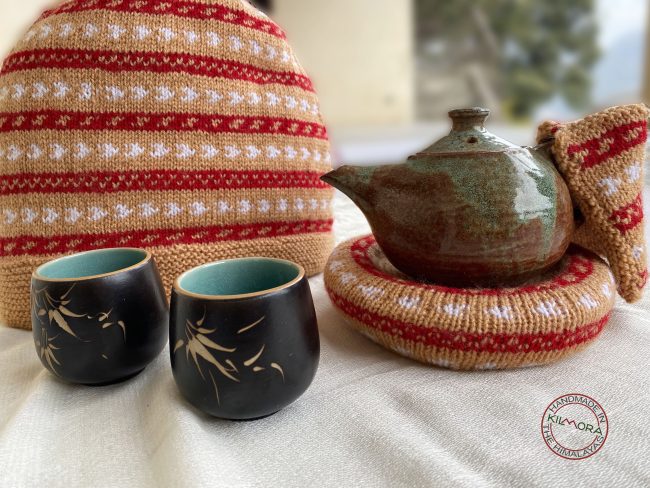 Hand knit woollen tea cosie set with a base, teapot cover and a flap to hold the handle