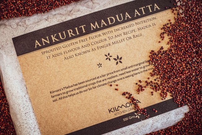 Label saying Ankurit Madua Atta or Sprouted Finger millet Flour with sprouted finger millet strewn across the packet