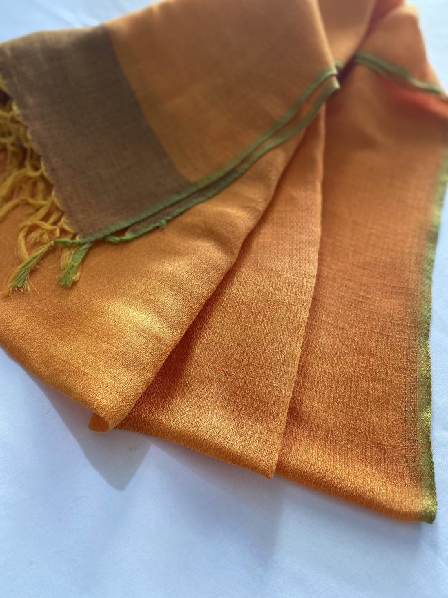 Cotton linen handwoven stole in a classic combination of royal orange with a border of burnt amber. And herringbone patterned olive green selvedge.