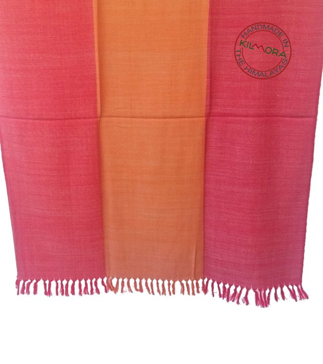 Pure woollen shawl from Kilmora in bold horizontal stripes of shades of raspberry, coral and crimson, underlaid with a weft of white.