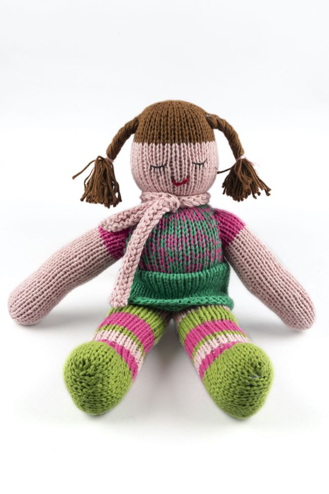 Hand-knit cotton doll with green and pink stockings, green skirt and a pink top