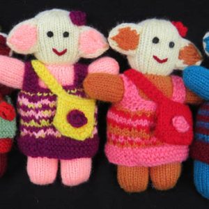 group of 4 knitted soft toys of little girls with small bag slung crossways