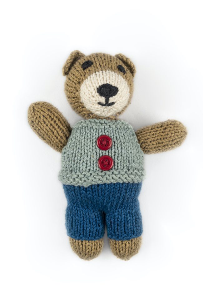 Hand-knit toy bear with dark blue trouser, light blue vest with red buttons