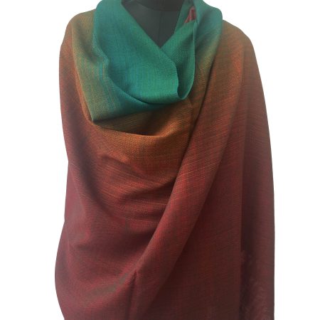 Handwoven merino wool shawl in Kilmora's signature gradation weave. Ranging from deep maroon to rust to orange, yellow and pine green.