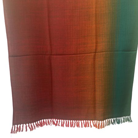 Handwoven merino wool shawl in Kilmora's signature gradation weave. Ranging from deep maroon to rust to orange, yellow and pine green.