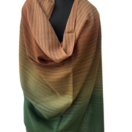 Merino wool handwoven shawl in gradation with shades ranging from brunt umber to orange to yellow and ending with pine green