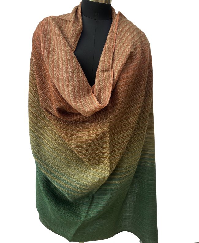 Merino wool handwoven shawl in gradation with shades ranging from brunt umber to orange to yellow and ending with pine green