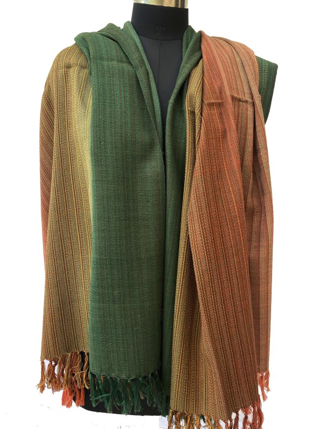 Merino wool handwoven shawl in gradation with shades ranging from brunt umber to orange to yellow and ending with pine green