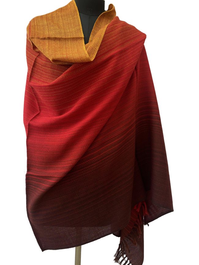 Meirno wool handwoven shawl in gradtion with shades ranging from deep maroon to crimson and tangerine