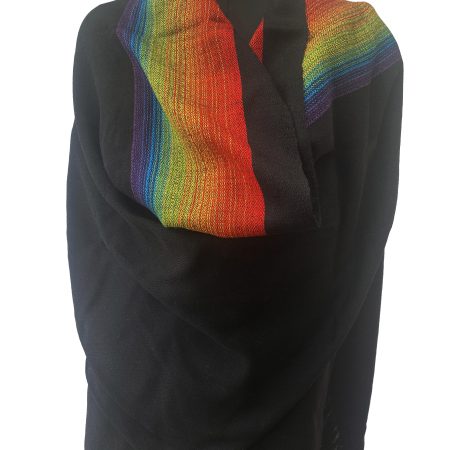 Black merino wool shawl with a border on one side of indigo, blue, yellow, green and red