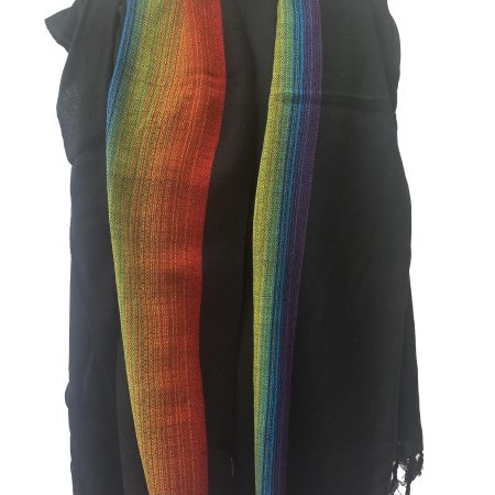 Black merino wool shawl with a border on one side of indigo, blue, yellow, green and red