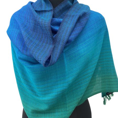 Merino wool handwoven stole in gradient weave in shades of emerald green, ultramarine blue and azure