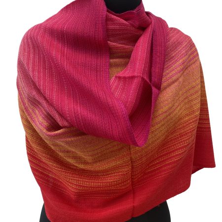 Handwoven merino wool stole in gradation in shades of scarlet, pomegranate and ruby red with a hint of citrus yellow