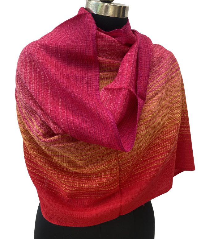 Handwoven merino wool stole in gradation in shades of scarlet, pomegranate and ruby red with a hint of citrus yellow