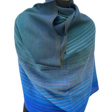 Merino wool handwoven stole in gradation weave in shades - from left right - peacock blue, oceanic blue, slate and azure