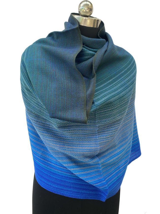 Merino wool handwoven stole in gradation weave in shades - from left right - peacock blue, oceanic blue, slate and azure