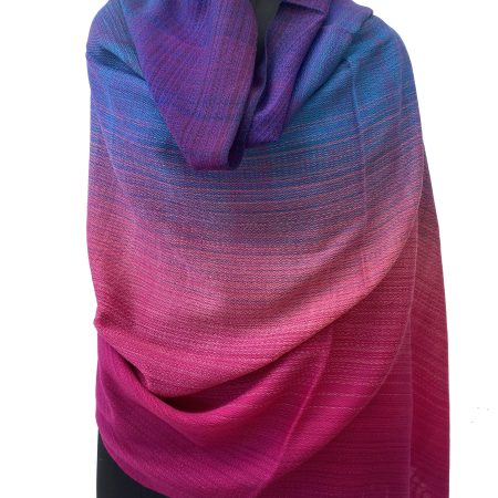 Handwoven merino wool shawl in gradation with shades from deep violet to azure, blush pink and a deep raspberry pink