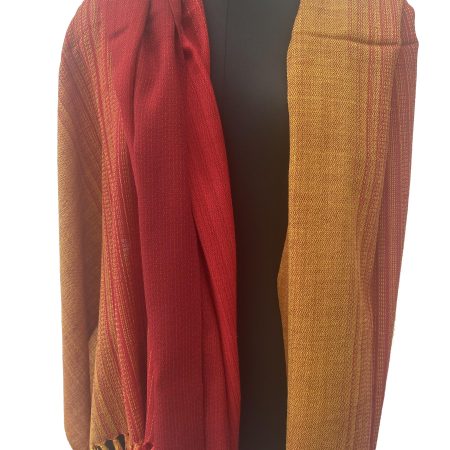 Handwoven merino wool shawl in gradation with shades from deep apricot to tangerine and ending in mahogany