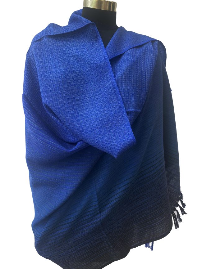 Handwoven merino wool shawl in gradation ranging from azure to sapphireto midnight and royal blue