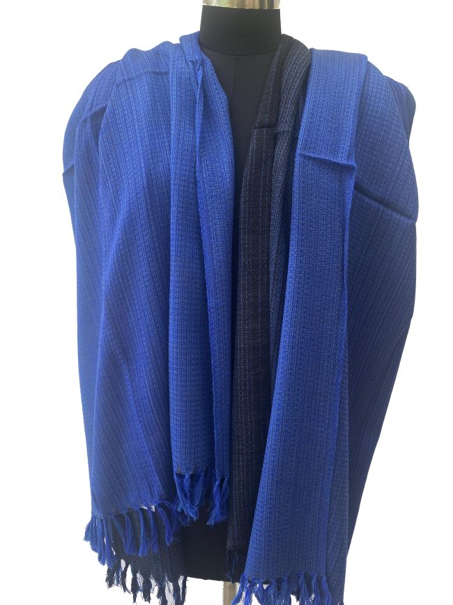 Handwoven merino wool shawl in gradation ranging from azure to sapphireto midnight and royal blue