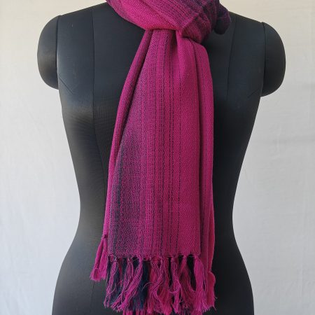 Merino wool stole knotted on a mannequin. In gradation weave - in shades of raspberry pink with amethyst on the sides