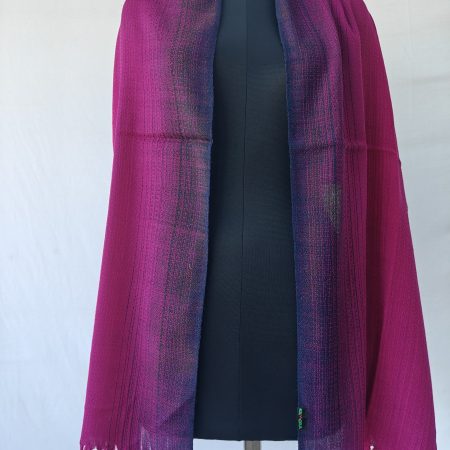 Merino wool stole draped on a mannequin. In gradation weave - in shades of raspberry pink with amethyst on the sides