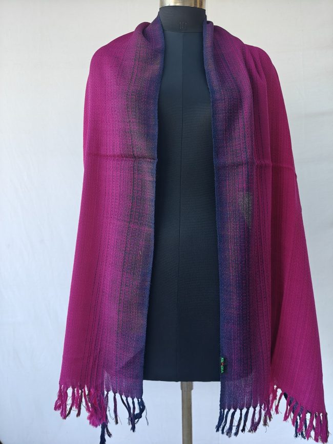 Merino wool stole draped on a mannequin. In gradation weave - in shades of raspberry pink with amethyst on the sides