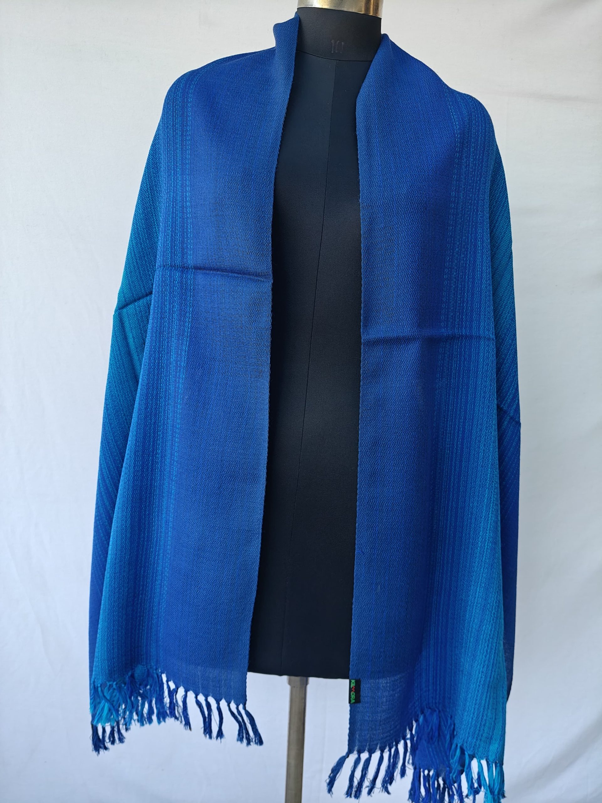 Ombre shades in this merino wool stole. Of arctic icy blue and blazing sapphire