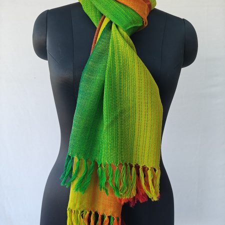 Merino wool stole knotted on a mannequin. In gradation weave - in shades of forest, shamrock and lime green followed by autumnal orange and mahogany